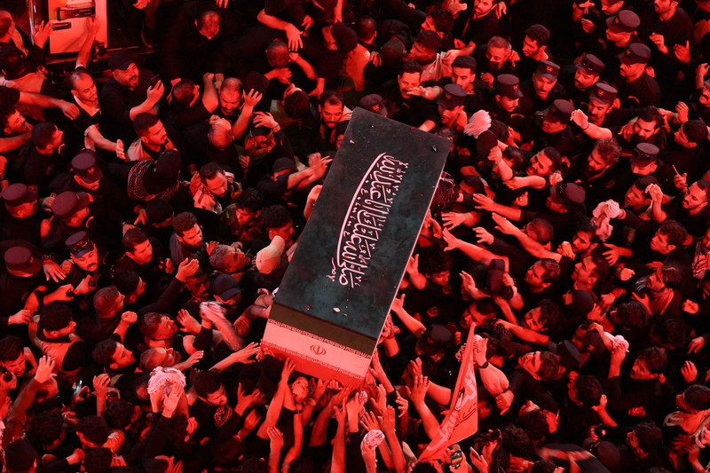 People carry the coffin of Iran's late Supreme Leader Ayatollah Ali Khamenei, who was killed on February 28 in Israeli and U.S. airstrikes, after it was unloaded from a refrigeration vehicle, during his funeral procession, in Karbala, Iraq, July 9, 2026. REUTERS/Ahmed Saad