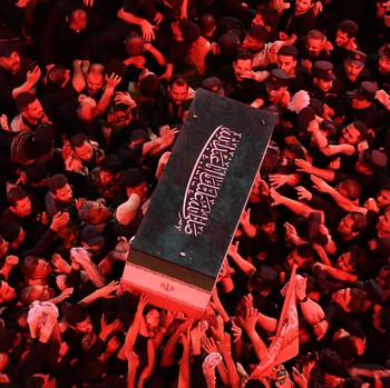 People carry the coffin of Iran's late Supreme Leader Ayatollah Ali Khamenei, who was killed on February 28 in Israeli and U.S. airstrikes, after it was unloaded from a refrigeration vehicle, during his funeral procession, in Karbala, Iraq, July 9, 2