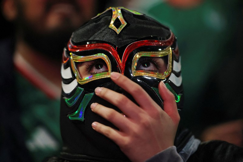 Soccer Football - FIFA World Cup 2026 - Mexico v South Africa -  Fans gather in Mexico City - Zocalo, Mexico City, Mexico - June 11, 2026 - A giant FIFA World Cup 2026 ball behind Mexico fans reacting as they watch the match REUTERS/Marian Carrasquero     TPX IMAGES OF THE DAY          SEARCH