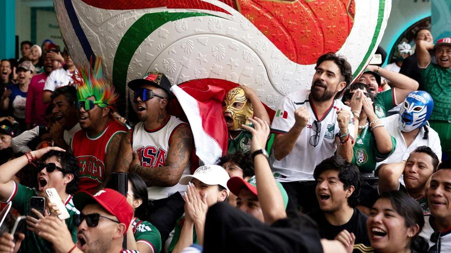 Soccer Football - FIFA World Cup 2026 - Mexico v South Africa -  Fans gather in Mexico City - Zocalo, Mexico City, Mexico - June 11, 2026 - A giant FIFA World Cup 2026 ball behind Mexico fans reacting as they watch the match REUTERS/Marian Carrasquer