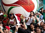 Soccer Football - FIFA World Cup 2026 - Mexico v South Africa -  Fans gather in Mexico City - Zocalo, Mexico City, Mexico - June 11, 2026 - A giant FIFA World Cup 2026 ball behind Mexico fans reacting as they watch the match REUTERS/Marian Carrasquer