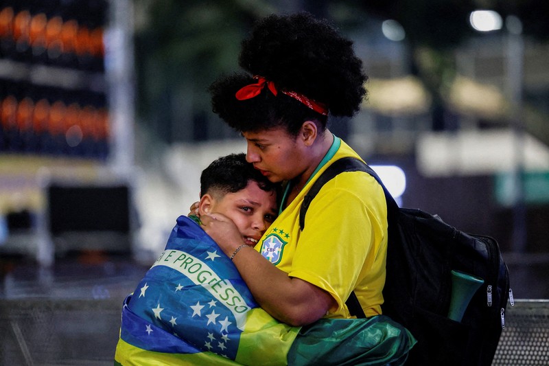Soccer Football - FIFA World Cup 2026 - Mexico v South Africa -  Fans gather in Mexico City - Zocalo, Mexico City, Mexico - June 11, 2026 - A giant FIFA World Cup 2026 ball behind Mexico fans reacting as they watch the match REUTERS/Marian Carrasquero     TPX IMAGES OF THE DAY          SEARCH