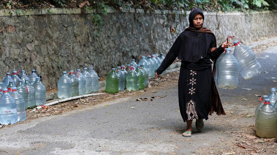 Penduduk desa mengumpulkan air mata air di daerah yang dilanda kekeringan selama musim kemarau, di tengah perkiraan bahwa El Niño dapat menyebabkan kondisi yang lebih kering dari biasanya, di desa Gunung Batur, Cilegon. (REUTERS/Ajeng Dinar Ulfiana)