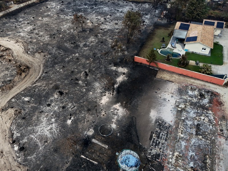 Foto udara menunjukkan rumah yang terbakar di daerah yang terkena dampak kebakaran hutan, di Le Porge, Gironde, di tengah kondisi kekeringan yang memburuk setelah gelombang panas dan kekurangan air di sebagian besar wilayah Prancis, Minggu (26/7/2026). (REUTERS/Manon Cruz)