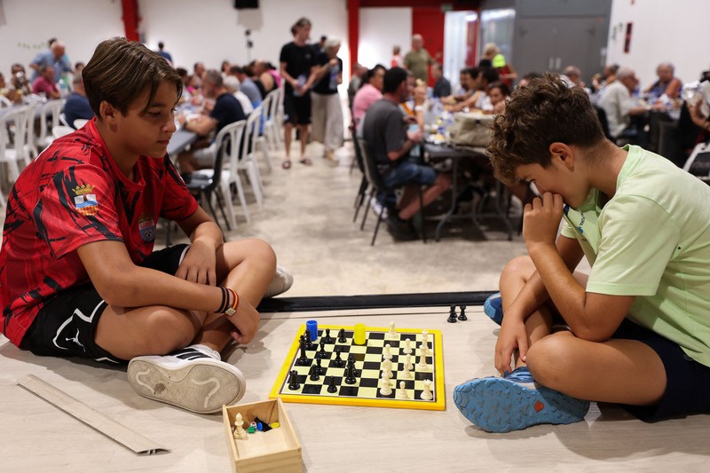Warga dari desa-desa yang dievakuasi duduk untuk makan sambil berlindung di pusat olahraga di Moncofa, Castellon, Spanyol, 26 Juli 2026. (REUTERS/Eva Manez)