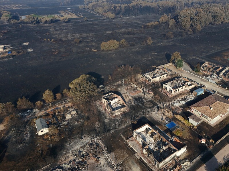 A drone view shows burnt buildings in an area affected by a wildfire in Le Porge, Gironde, amid drought conditions following a heatwave and water shortages across much of France, July 28, 2026. REUTERS/Yves Herman

     TPX IMAGES OF THE DAY