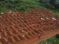 A drone view of workers at the Ceca-20 cemetery, as aid agencies intensify efforts to contain an Ebola outbreak caused by the Bundibugyo virus, in Mungwalu, Djugu Territory of Ituri province, Democratic Republic of Congo, July 14, 2026. REUTERS/Grade