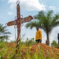 Charles Mambo, the supervisor at the Ceca-20 cemetery, flanked by Moise Mund'wa, the assistant warden of the cemetery, talks near graves during an interview with Reuters, as aid agencies intensify efforts to contain an Ebola outbreak caused by the Bu