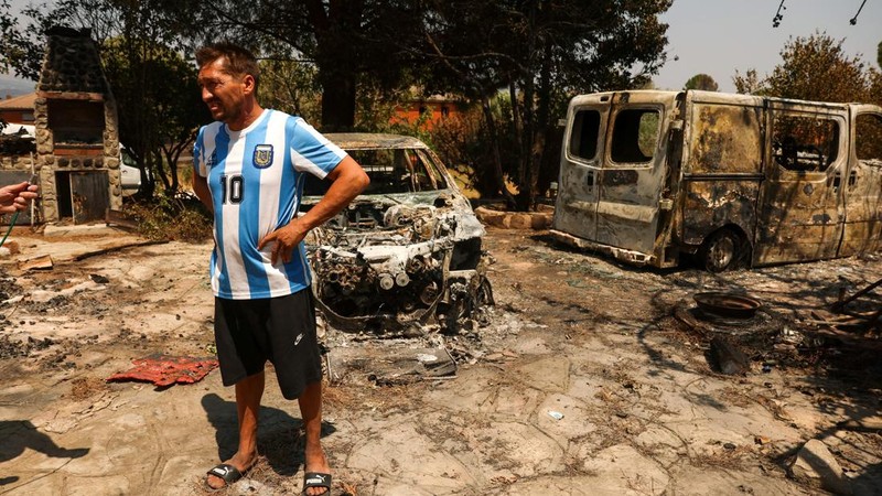Luis Gonzalez berdiri di tengah-tengah properti yang terbakar dan rusak di desa El Tiemblo, saat kebakaran hutan terus melanda provinsi Avila dan Madrid, Spanyol, 28 Juli 2026. (REUTERS/Violeta Santos Moura)