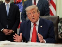 U.S. President Donald Trump speaks as he sits behind an airport model as he makes an announcement about a $22.5 billion renovation of Washington Dulles International Airport with U.S. Secretary of Transportation Sean Duffy (not pictured) in the Oval