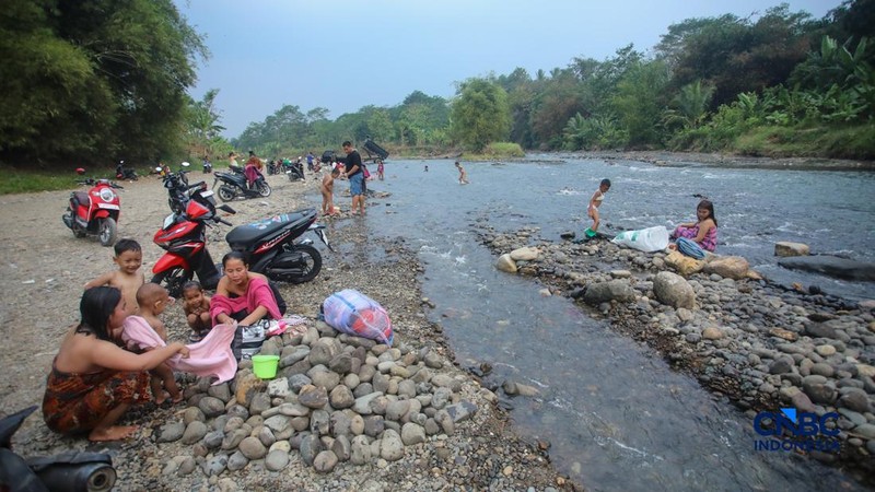 Warga beraktivitas pada aliran Sungai Ciberang di Kampung Somang, Lebak, Banten, Kamis (30/7/2026).