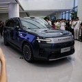 A woman takes photos of a Xiaomi SkyNomad N90 Max EREV (Extended-Range Electric Vehicle) on display before the car's launch event, in Xiaomi's industrial park, in Beijing, China July 30, 2026. REUTERS/Tingshu Wang