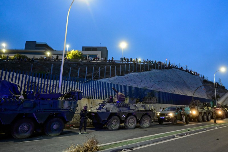 Migrants from Morocco cross into Ceuta by sea and gather near the border fence between the Spanish enclave of Ceuta and Morocco, as seen from Ceuta, Spain, July 30, 2026. REUTERS/Fabian Bimmer