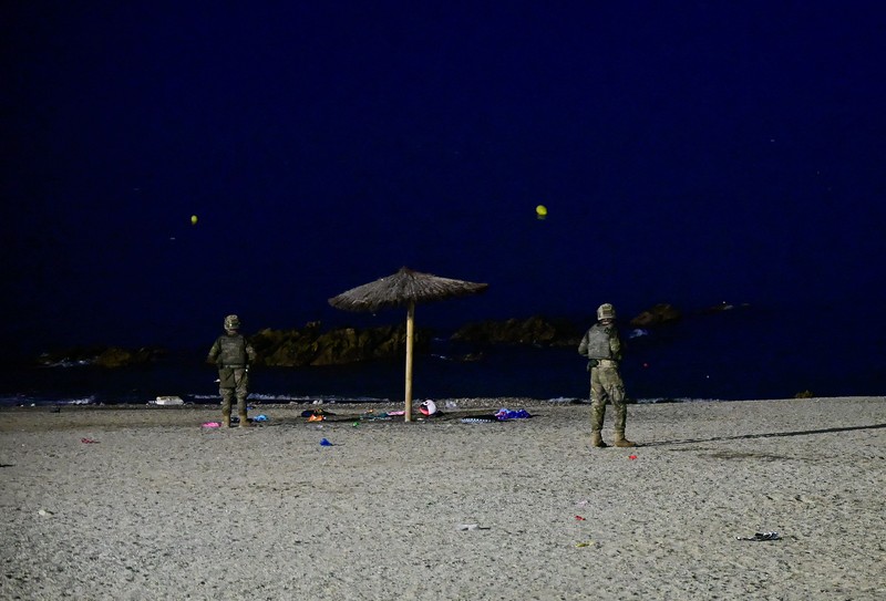 Migrants from Morocco cross into Ceuta by sea and gather near the border fence between the Spanish enclave of Ceuta and Morocco, as seen from Ceuta, Spain, July 30, 2026. REUTERS/Fabian Bimmer