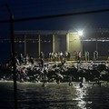 Migrants from Morocco cross into Ceuta by sea and gather near the border fence between the Spanish enclave of Ceuta and Morocco, as seen from Ceuta, Spain, July 30, 2026. REUTERS/Fabian Bimmer