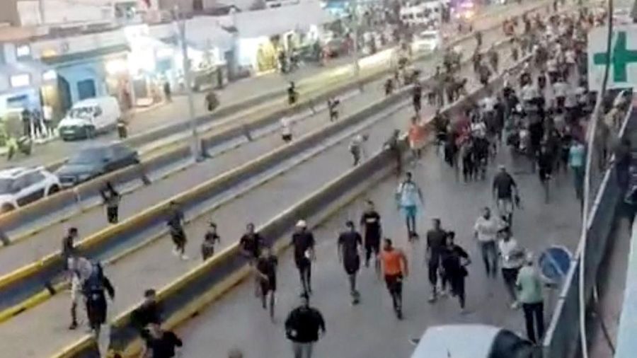 People run near the border-crossing complex in Beni Ansar, Morocco, in this still image obtained from social media video released July 30, 2026.   SOCIAL MEDIA/via REUTERS  THIS IMAGE HAS BEEN SUPPLIED BY A THIRD PARTY. NO RESALES. NO ARCHIVES. NEWS