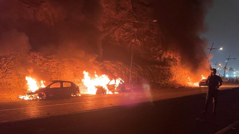 Vehicles burn in Fnideq, Morocco, July 31, 2026, as migrants (not pictured) wait for a chance to cross to the Spanish enclave of Ceuta. Picture taken with a mobile phone.   REUTERS/Ahmed El Jechtimi