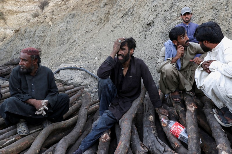 People gather after an explosion buried parts of a coal mining complex on the outskirts of Quetta, Pakistan, July 30, 2026. REUTERS/Naseer Ahmed