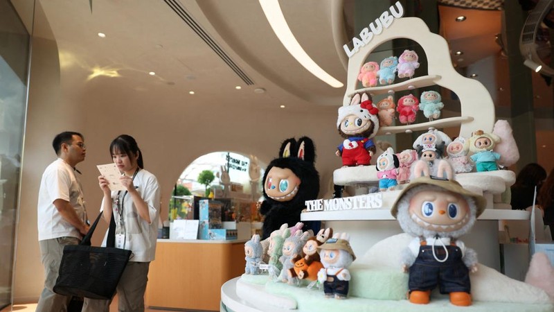 Para tamu menunggu di samping rak berisi mainan Labubu di toko roti internasional pertama Pop Mart selama acara media day mereka di Resorts World Sentosa di Singapura pada 29 Juli 2026.