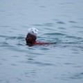 Moussa Khamiss, 17, from Sudan, carries his documents inside a bottle as he crosses into Ceuta by sea, at El Tarajal beach, amid mass crossings of migrants from Morocco into Spanish territory, in Ceuta, Spain, July 31, 2026. REUTERS/Jon Nazca