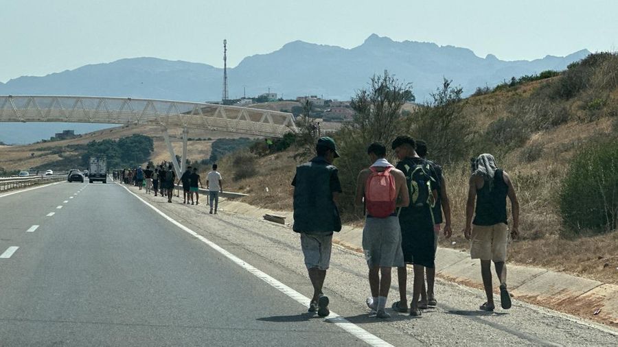 Migrants walk back after crossing from the Spanish enclave of Ceuta, to the Moroccan side of the border in Fnideq, Morocco, July 31, 2026. Picture taken by a phone. REUTERS/Stringer