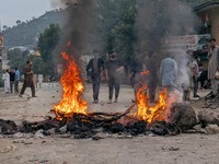 Pendukung Komite Aksi Awami Bersama (JAAC) yang dilarang, sebuah aliansi kelompok masyarakat sipil, membakar jalan untuk memblokir jalan selama protes di Muzaffarabad, Kashmir Pakistan, 31 Juli 2026. Foto diambil dengan telepon seluler. REUTERS/Strin