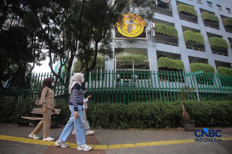 Warga melintas di samping pagar Blok M Plaza, Jakarta, Senin (3/8/2026). Polemik pemasangan pagar tinggi di sejumlah pusat perbelanjaan di Jakarta mencuri perhatian setelah beberapa mal memasang pagar besi yang mengelilingi area bangunan. (CNBC Indonesia/Faisal Rahman)