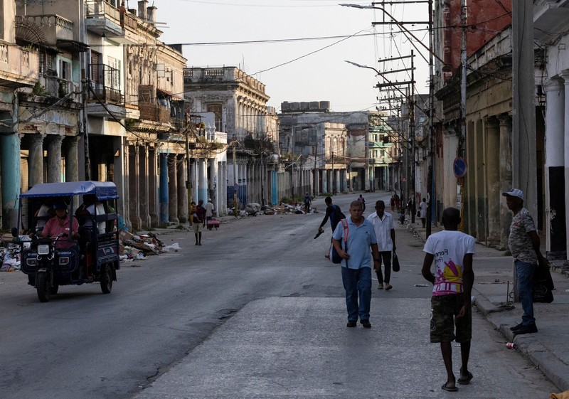 Seorang pria mengendarai sepeda sambil menyeberang jalan saat jaringan listrik nasional Kuba mengalami gangguan pada hari Minggu, kegagalan jaringan listrik nasional keempat dalam waktu kurang dari sebulan, di Havana, Kuba, 3 Agustus 2026. (REUTERS/Norlys Perez)