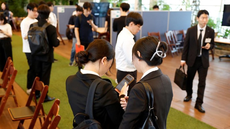 Para pencari kerja Korea Selatan melihat ponsel pintar bersama-sama selama pameran kerja yang menghubungkan pelamar dengan pemberi kerja Jepang di Seoul, Korea Selatan, 12 Juli 2026.