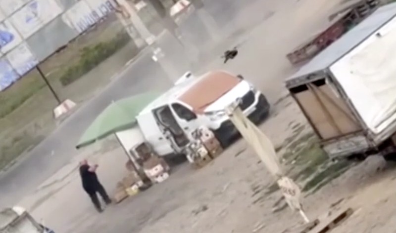 Seorang pedagang sayur di kota Kherson, Ukraina selatan, terluka setelah diduga dikejar pesawat nirawak (drone) Rusia sebelum perangkat tersebut meledak di samping mobil van yang dijadikannya lapak pasar, Selasa (4/8/2026). (Tangkapan Layar Video Reuters/)