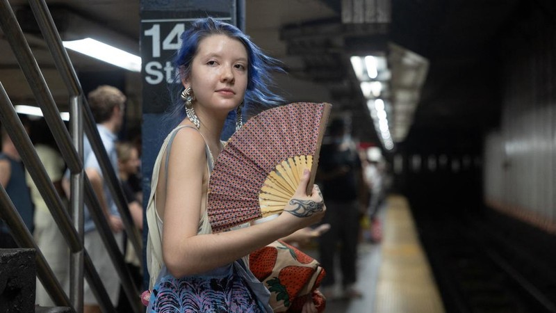 Seorang wanita mengipasi dirinya di stasiun kereta bawah tanah saat gelombang panas melanda New York City, AS, pada 7 Agustus 2026.