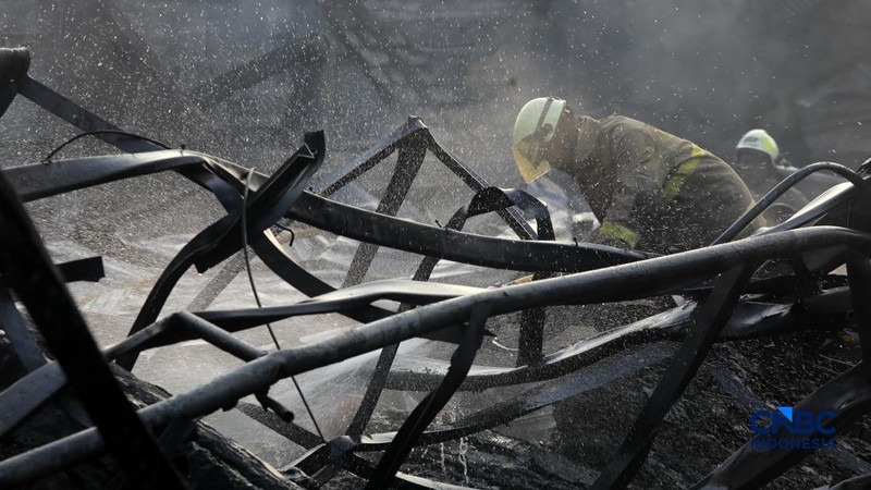 Sejumlah petugas pemadam kebakaran berusaha memadamkan api di sebuah pabrik bingkai yang terbakar, di Jalan Lampiri, Jakarta Timur, Rabu (12/08/2026). (CNBC Indonesia/Muhammad Sabki)