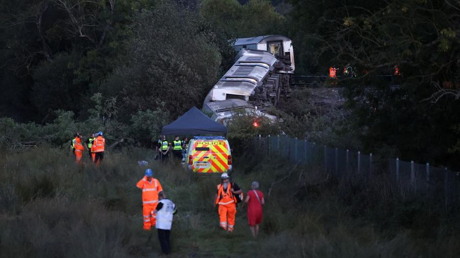 Petugas darurat bekerja di lokasi kejadian di samping kereta yang terguling setelah kereta penumpang layanan Southern tergelincir di dekat Lewes, Inggris tenggara, Kamis (13/8/2026). (REUTERS/Toby Shepheard)