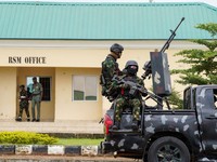 Armed military men keep watch from a military truck during a public destruction exercise at the Muhammadu Buhari Cantonment in Abuja, Nigeria, July 30, 2026. REUTERS/ Marvellous Durowaiye