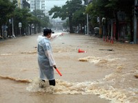 A police officer controls a road covered with floodwaters following the torrential rain in Geoje, South Korea, August 17, 2026.    Yonhap via REUTERS   THIS IMAGE HAS BEEN SUPPLIED BY A THIRD PARTY. NO RESALES. NO ARCHIVES. SOUTH KOREA OUT. NO COMMER