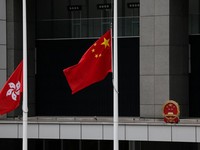 Chinese and Hong Kong flags fly at half-mast at the Central Government Offices on the day of the cremation of former Chinese Premier Zhu Rongji, in Hong Kong, China, August 18, 2026. REUTERS/Tyrone Siu