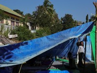 A girl looks on from a makeshift tent serving as temporary shelter for people affected by the earthquake in Reok, East Nusa Tenggara province, Indonesia, August 18, 2026. REUTERS/Willy Kurniawan