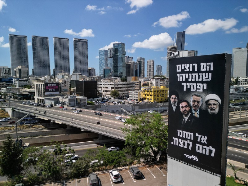A drone view of an election billboard by Benjamin Netanyahu's Likud Party depicting Iran's Supreme Leader Mojtaba Khamenei, New York City Mayor Zohran Mamdani, Turkish President Tayyip Erdogan and Hezbollah chief Naim Qassem and a text in Hebrew that reads