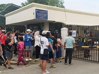 People stand outside Ateneo de Zamboanga University after a shooting that killed two people, in Zamboanga, southern Philippines, August 18, 2026. REUTERS/Nonoy Lacson     TPX IMAGES OF THE DAY