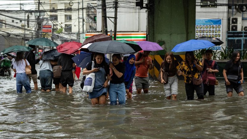 Warga menerjang banjir saat hujan deras musim monsun di Kota Manila, Filipina, Senin (17/8/2026). (REUTERS/Eloisa Lopez)