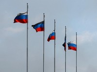 Flags fly outside a burnt-out hypermarket following an overnight attack, what Russian-installed authorities called a Ukrainian drone strike, in the course of the Russia-Ukraine conflict in Makiivka (Makeyevka) in the Donetsk region, a Russian control
