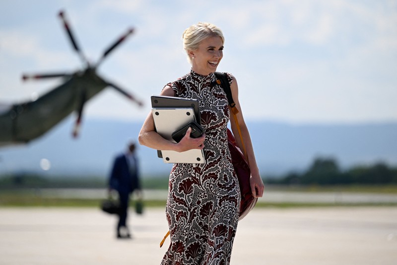 U.S. President Trump walks by his Executive assistant Natalie Harp as they attend a dignified transfer of the remains of U.S. Army service members, Army 1st Lt Tyler James Feehan, Sgt. Angel S. Rampersad, Pvt. Isabella Gonzales, killed during an attack on Muwaffaq Salti Air Base in Jordan, and Sgt. Michael Emmanuel Swinton, killed in action during a controlled detonation of a downed one-way unmanned aerial system at Erbil Air Base in Iraq, at Dover Air Force Base in Dover, Delaware, U.S., July 22, 2026. REUTERS/Evan Vucci