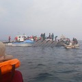 Rescue workers and local boat operators take part in ongoing search and recovery operations near the overturned passenger ferry on Lake Kariba, a day after the vessel capsized, in Kariba, Zimbabwe, August 12, 2026. REUTERS/Admore Mbonda PICTURE TAKEN
