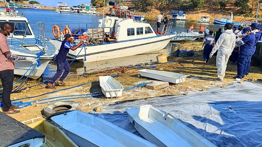 SENSITIVE MATERIAL. THIS IMAGE MAY OFFEND OR DISTURB Rescue and recovery personnel work along the shoreline of Lake Kariba during an operation to recover victims from a Rural Infrastructure Development Agency (RIDA) passenger ferry that capsized near