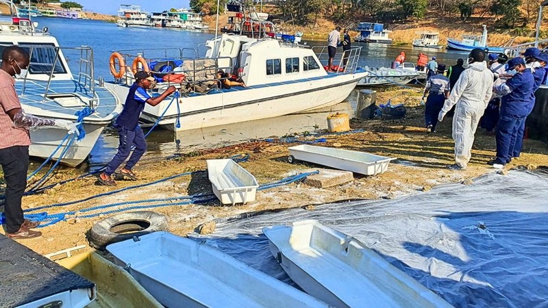 SENSITIVE MATERIAL. THIS IMAGE MAY OFFEND OR DISTURB Rescue and recovery personnel work along the shoreline of Lake Kariba during an operation to recover victims from a Rural Infrastructure Development Agency (RIDA) passenger ferry that capsized near