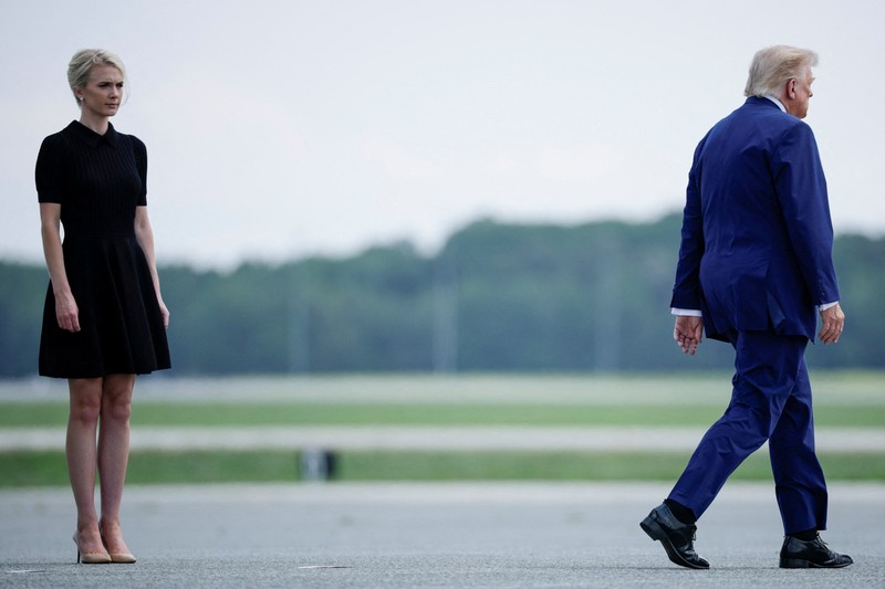 U.S. President Trump walks by his Executive assistant Natalie Harp as they attend a dignified transfer of the remains of U.S. Army service members, Army 1st Lt Tyler James Feehan, Sgt. Angel S. Rampersad, Pvt. Isabella Gonzales, killed during an attack on Muwaffaq Salti Air Base in Jordan, and Sgt. Michael Emmanuel Swinton, killed in action during a controlled detonation of a downed one-way unmanned aerial system at Erbil Air Base in Iraq, at Dover Air Force Base in Dover, Delaware, U.S., July 22, 2026. REUTERS/Evan Vucci