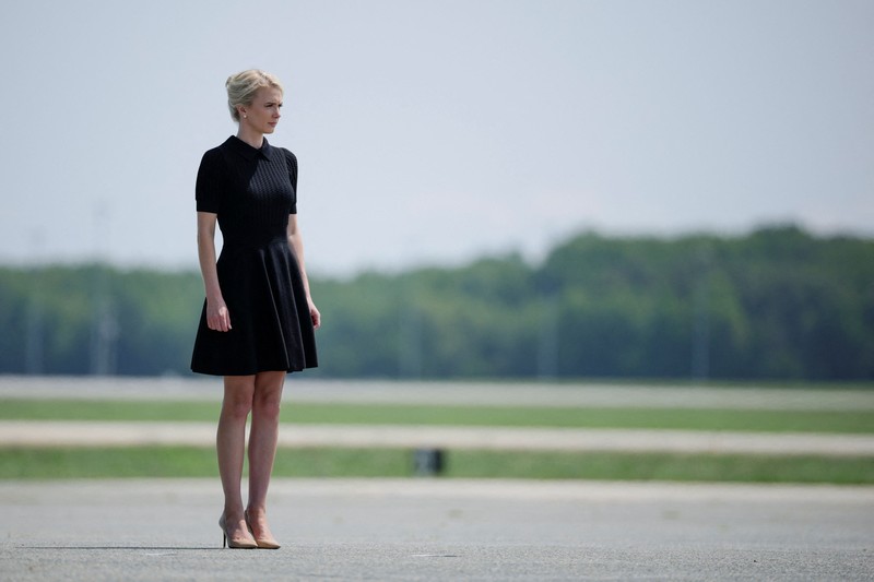 U.S. President Trump walks by his Executive assistant Natalie Harp as they attend a dignified transfer of the remains of U.S. Army service members, Army 1st Lt Tyler James Feehan, Sgt. Angel S. Rampersad, Pvt. Isabella Gonzales, killed during an attack on Muwaffaq Salti Air Base in Jordan, and Sgt. Michael Emmanuel Swinton, killed in action during a controlled detonation of a downed one-way unmanned aerial system at Erbil Air Base in Iraq, at Dover Air Force Base in Dover, Delaware, U.S., July 22, 2026. REUTERS/Evan Vucci