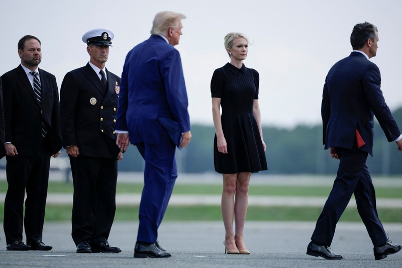 U.S. President Trump walks by his Executive assistant Natalie Harp as they attend a dignified transfer of the remains of U.S. Army service members, Army 1st Lt Tyler James Feehan, Sgt. Angel S. Rampersad, Pvt. Isabella Gonzales, killed during an attack on Muwaffaq Salti Air Base in Jordan, and Sgt. Michael Emmanuel Swinton, killed in action during a controlled detonation of a downed one-way unmanned aerial system at Erbil Air Base in Iraq, at Dover Air Force Base in Dover, Delaware, U.S., July 22, 2026. REUTERS/Evan Vucci