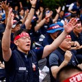 A member of the Korean Metal Workers' Union raises his arms during a rally outside Hyundai Motor Company headquarters as the automaker's union staged its first full strike in a decade, in Seoul, South Korea, August 21, 2026. REUTERS/Kim Soo-hyeon