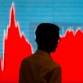 A man walks past a screen displaying news of markets update inside the Bombay Stock Exchange (BSE) building in Mumbai, India, February 6, 2018. (REUTERS/Danish Siddiqui  TPX IMAGES OF THE DAY)